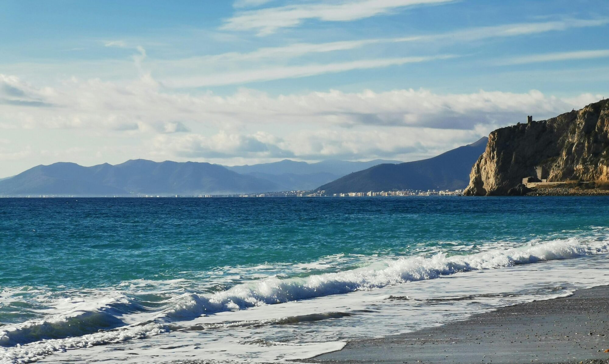 Explore the beautiful coastline of Finale Ligure with crashing waves and stunning cliffs.